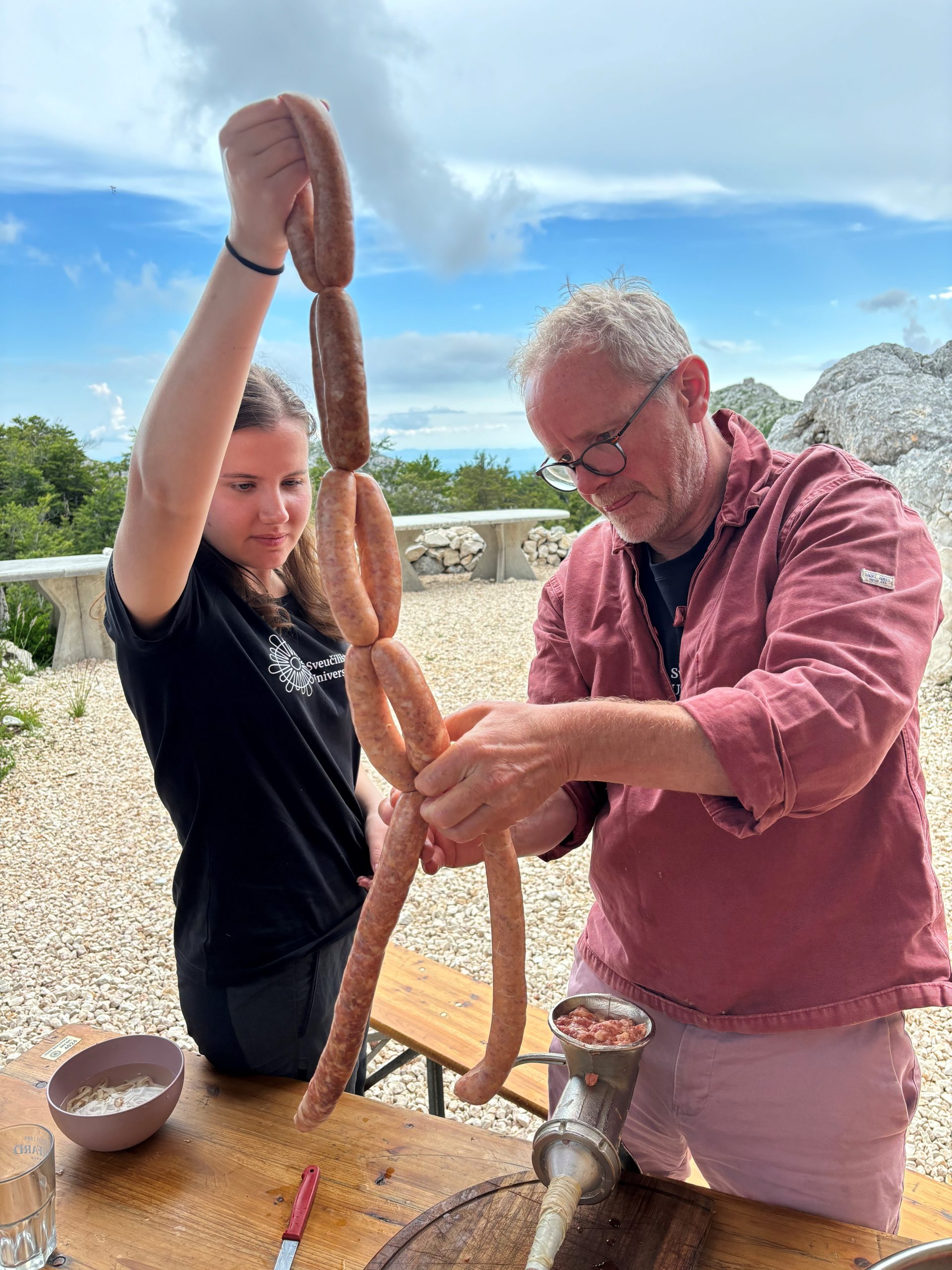 An archaeology student (Ivona Ćorak, UNIZD) and a culinary arts lecturer (Michael Quinn, SETU) recreate traditional sausages as part of the EcoEcho project on Mount Biokovo, Croatia.